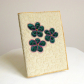 Quilted book cover w/ applique flowers.